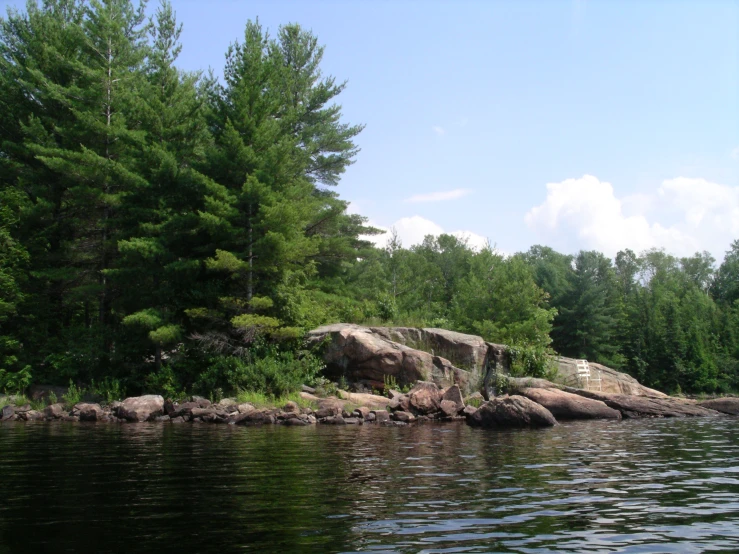 the water is calm and still moving in a natural area