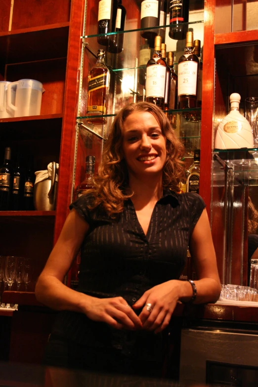 a woman is standing behind the counter in a wine shop