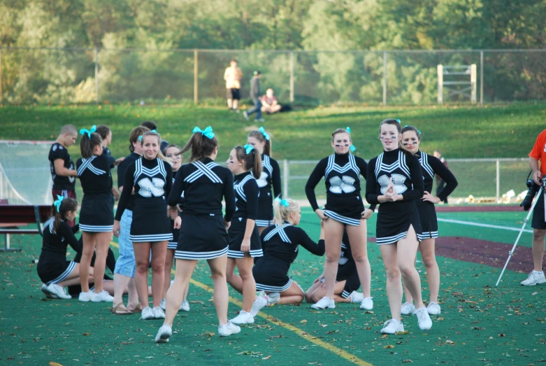 several cheerleaders standing in formation on the field