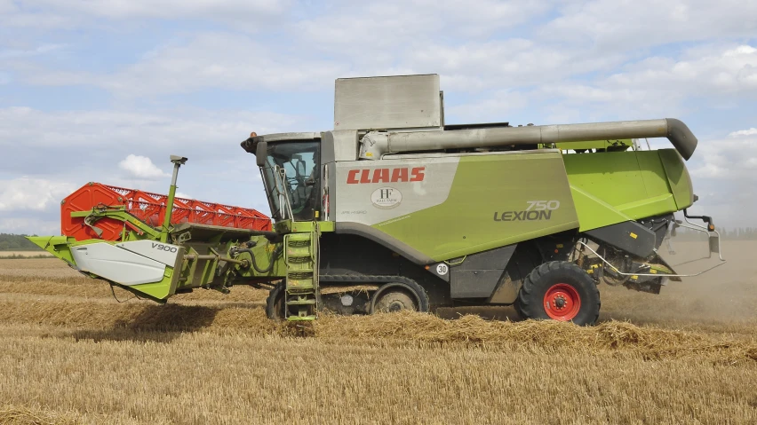 combine on a farm with grain harvesting equipment