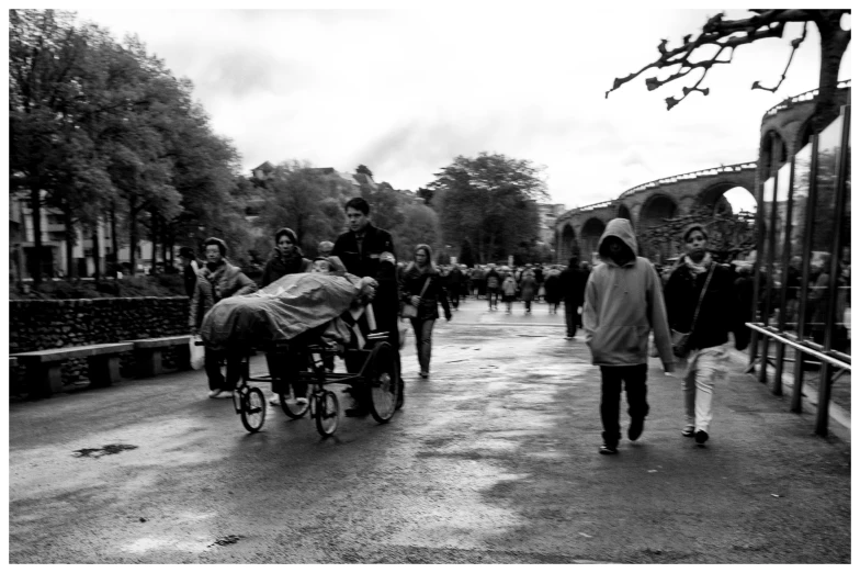 a couple of people walking past two women hing bikes