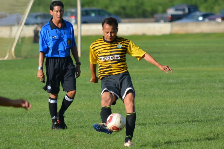 two soccer players are competing for the ball