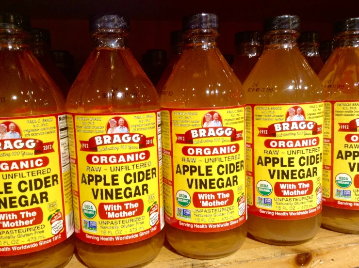 a collection of bottles of apple cider vinegar