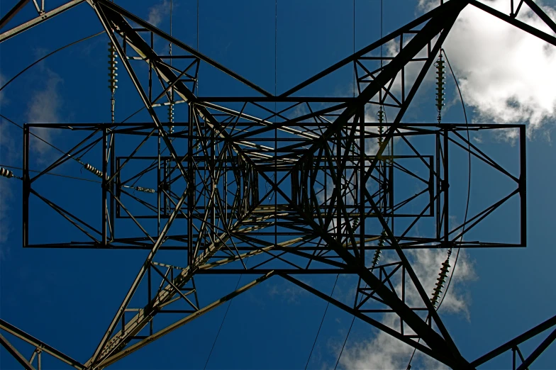 tall electric wire tower against a blue sky