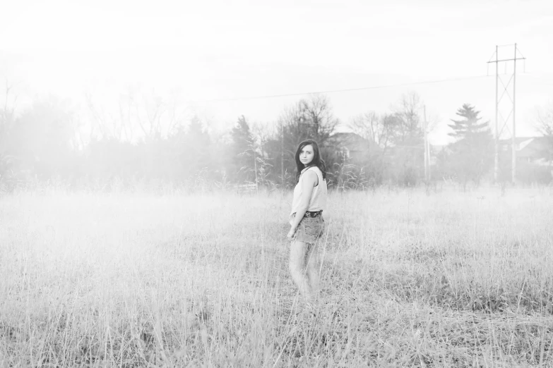 woman standing in the middle of grassy field