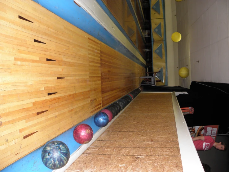 a bowling alley with several bowls at the bottom