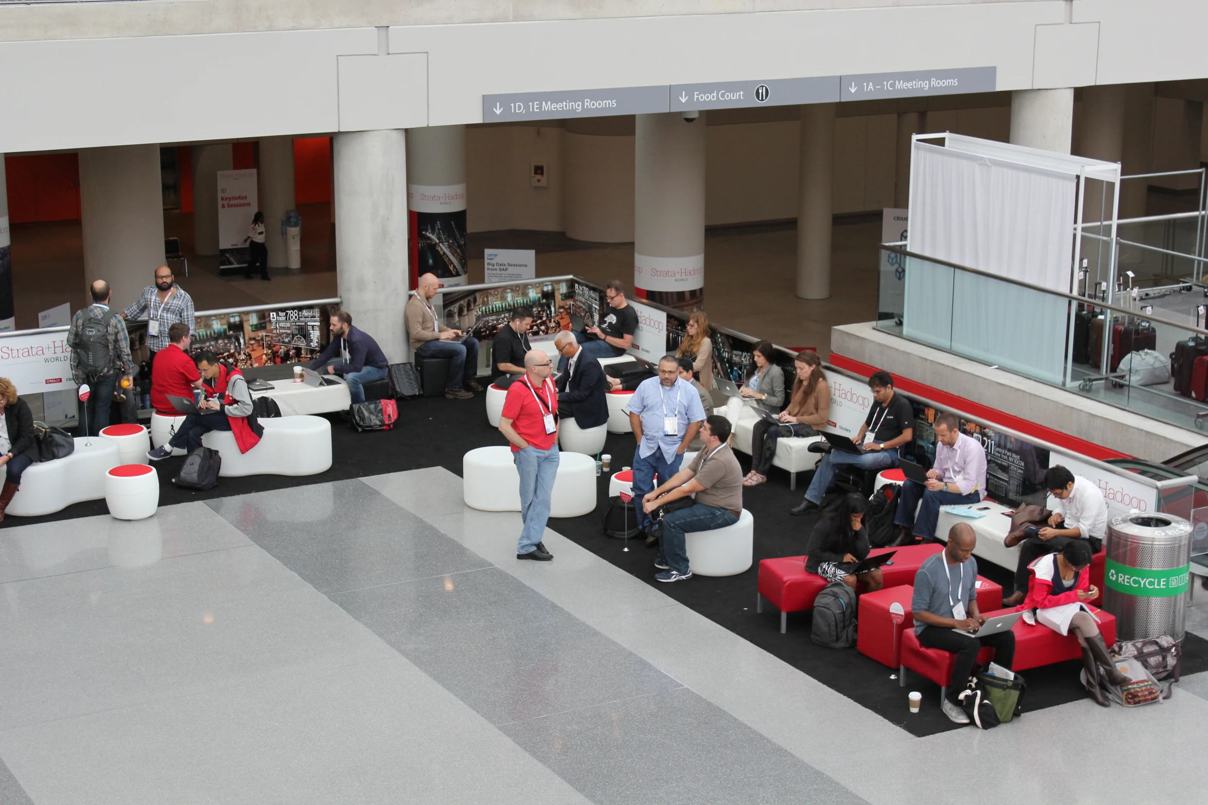 people with luggage sitting around a red and white room