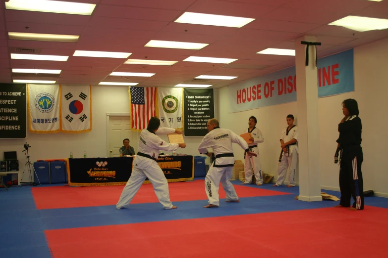 people with white belt standing on a red carpet
