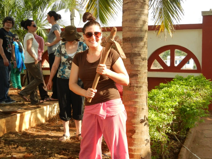 a young woman is holding a baseball bat