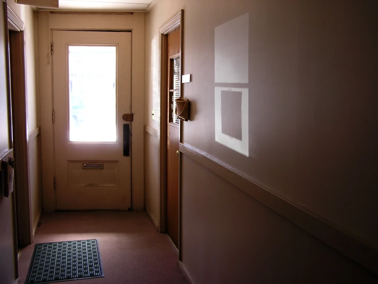 the entrance door of an apartment, showing light coming through