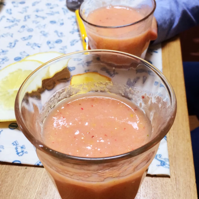 two glasses filled with different fruits and vegetables