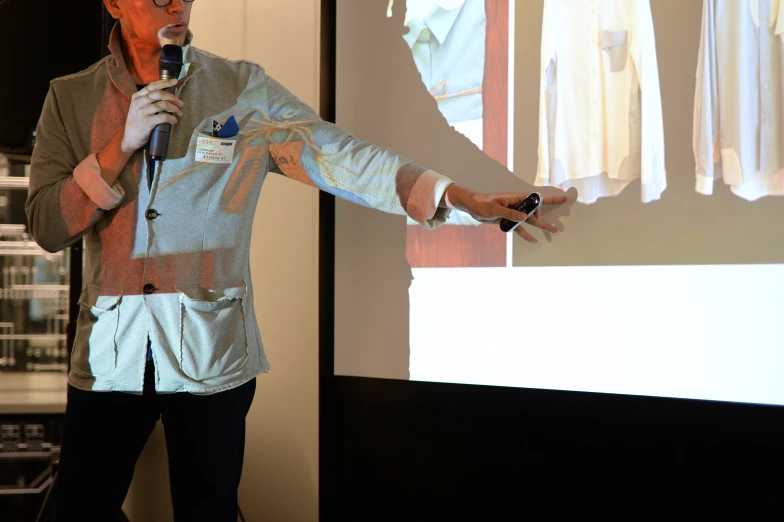 a man speaking into a microphone in front of an audience