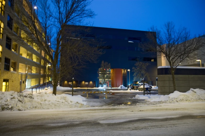 a city street is covered with snow near some buildings