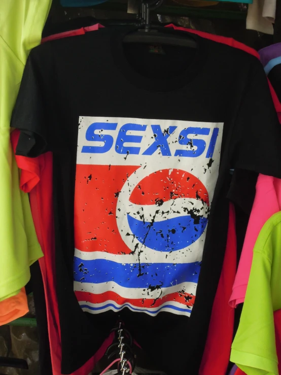 an image of a pepsi shirt in front of many shirts