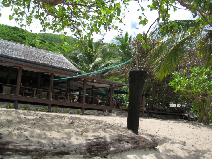 a wooden deck near a fence and green trees