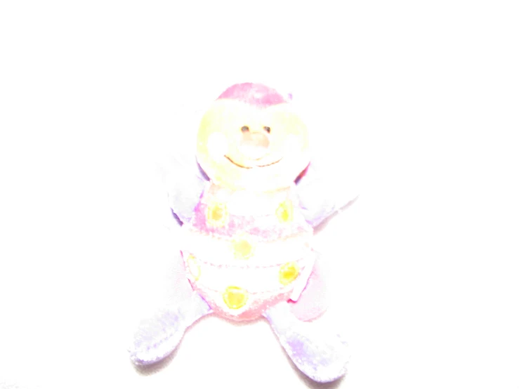 a teddy bear doll sitting on the ground