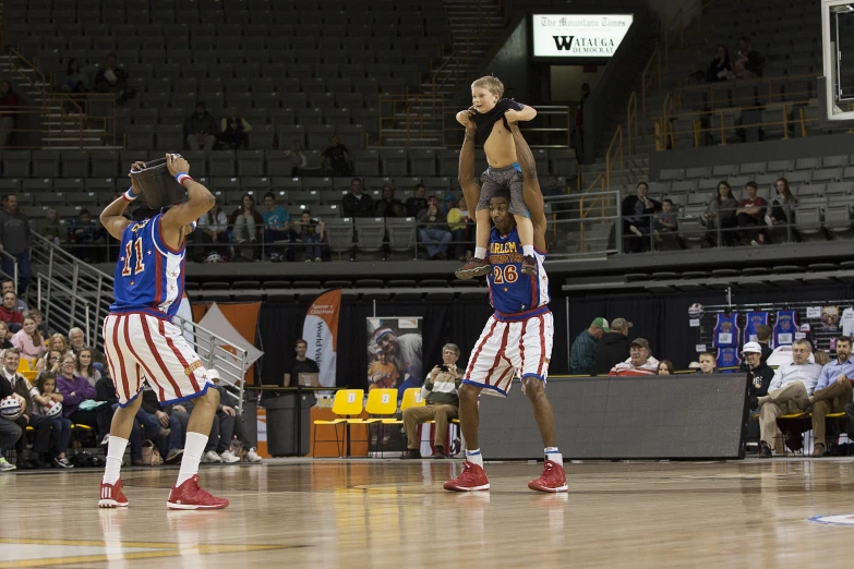 two people standing with their hands in the air while playing a game