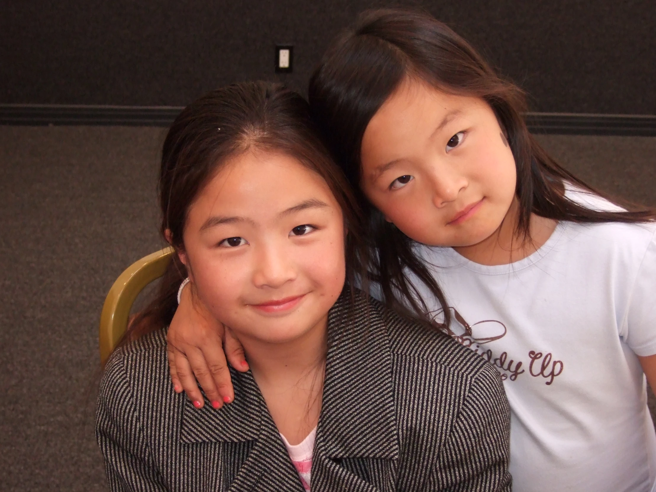 two girls who are sitting next to each other