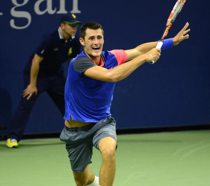 a male tennis player in the middle of playing