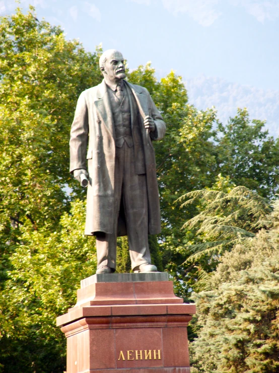 a statue of an old man with a black coat and white beard