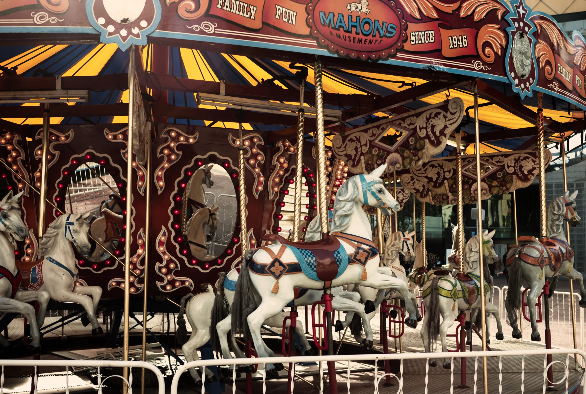 several old fashioned carousels are parked in front of an amut park