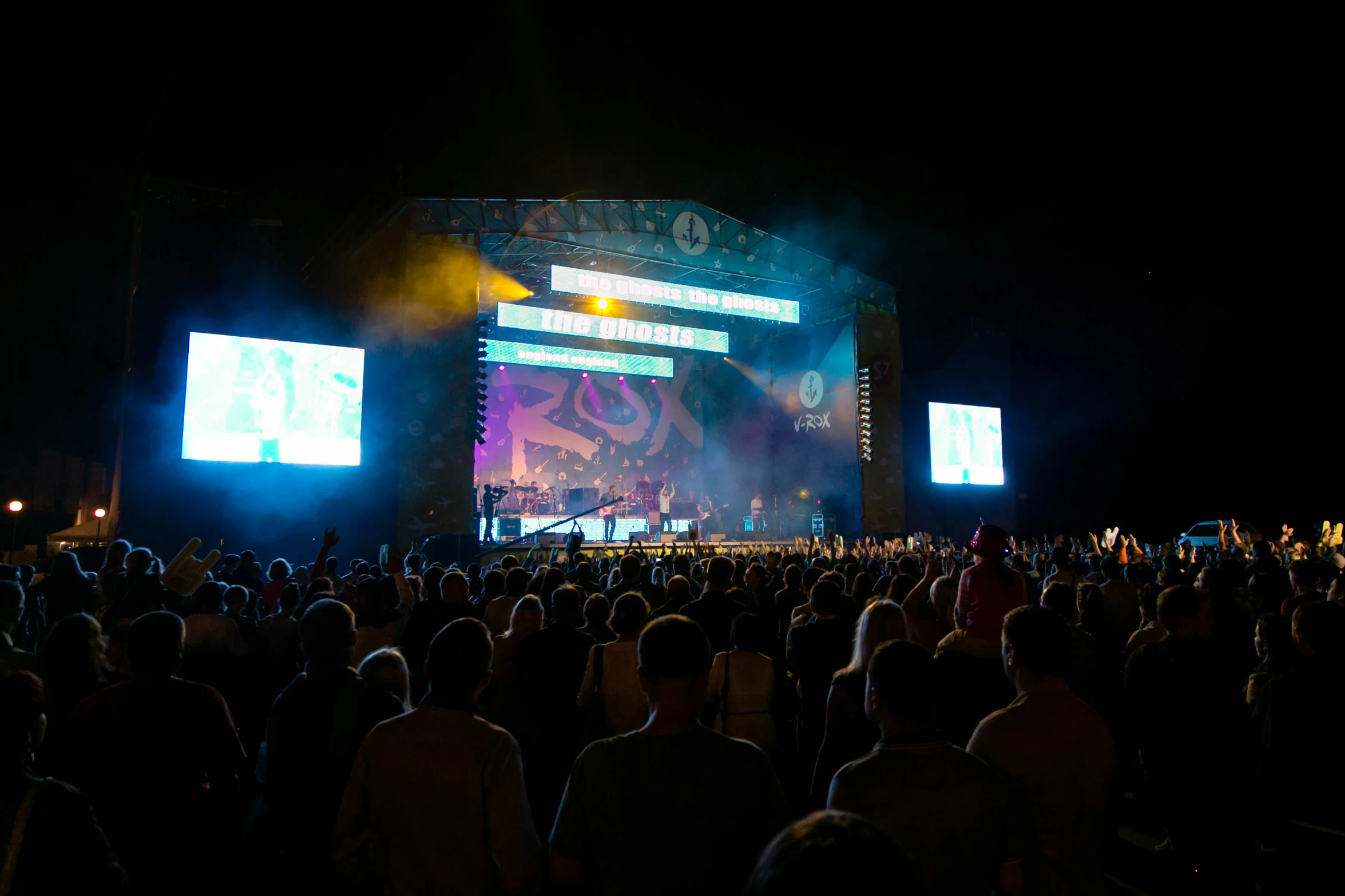 a large crowd is at an outdoor concert