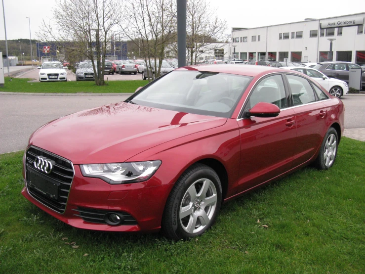 a red car parked in a grassy area