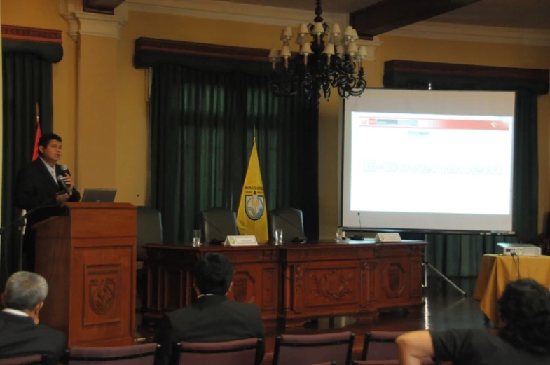 a man stands at a podium in front of an audience