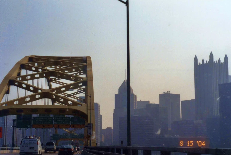 a city street with bridge over it and traffic driving across