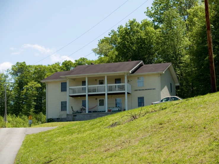 a two story house with the driveway near by