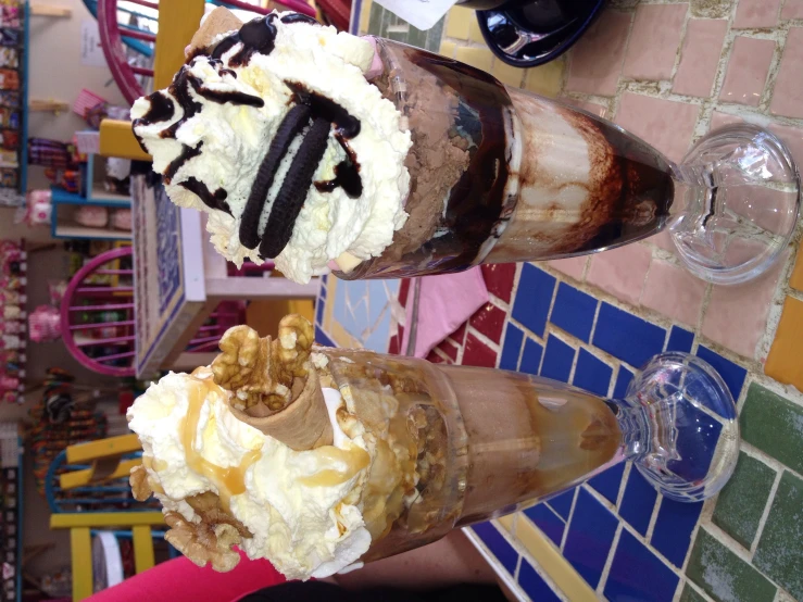 two large glasses filled with dessert ice creams