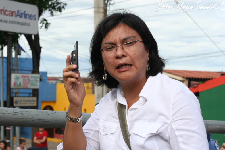 a woman holding her cell phone up to the camera