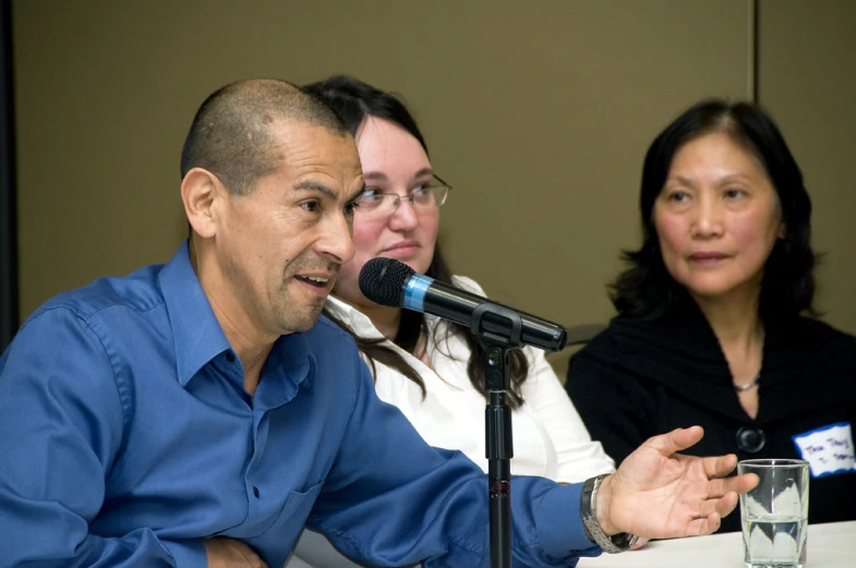 a man and woman in front of microphones talking