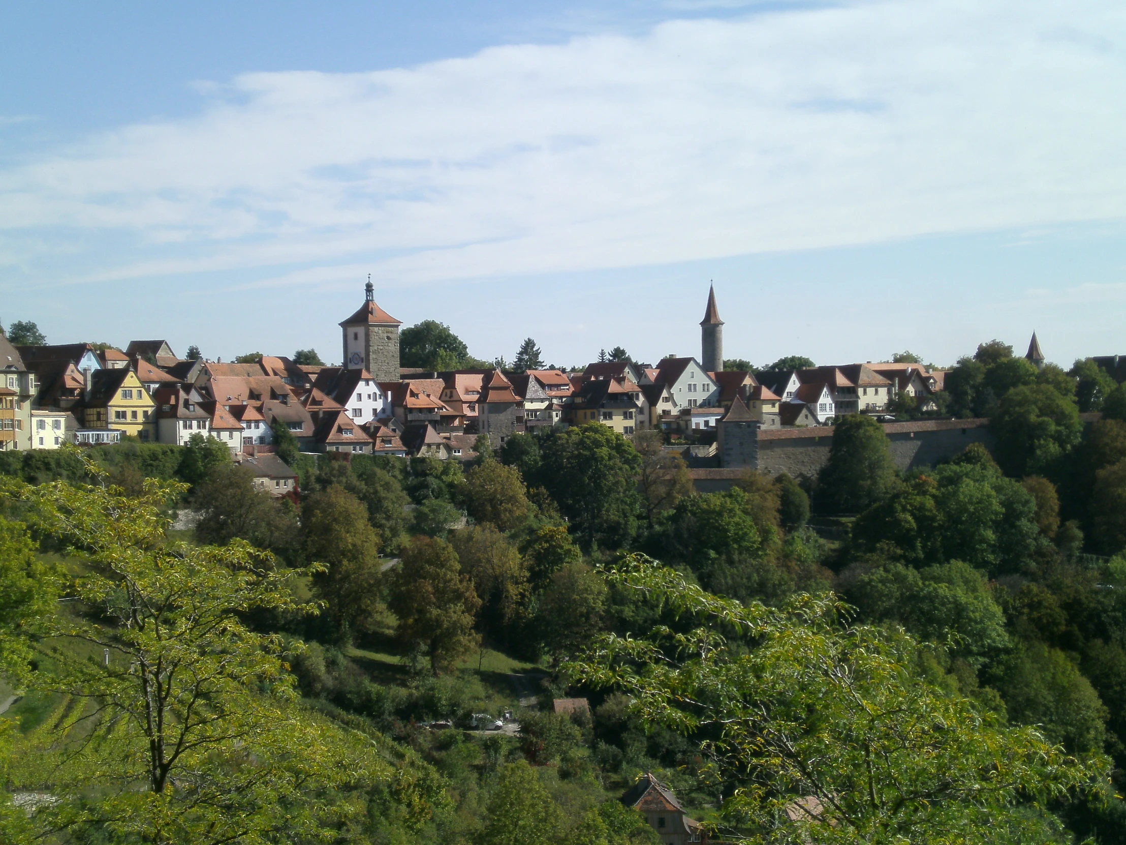 small town surrounded by trees and hills