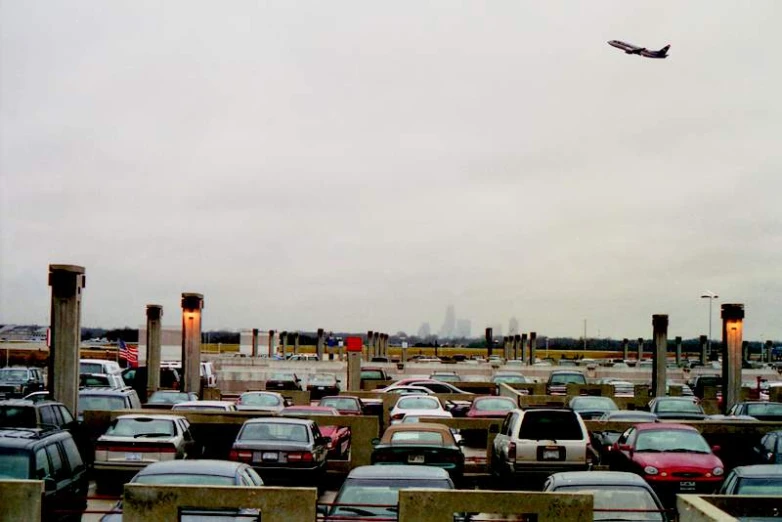 a large parking lot full of cars under a cloudy sky