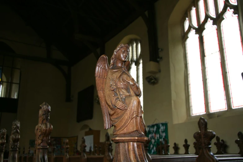 an ornate wooden figure is set on display in the church