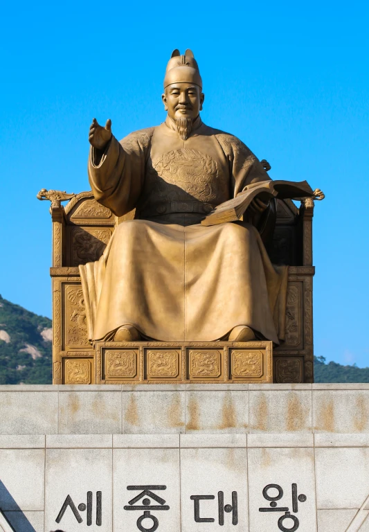 the statue of a man with a golden robe sits at the base