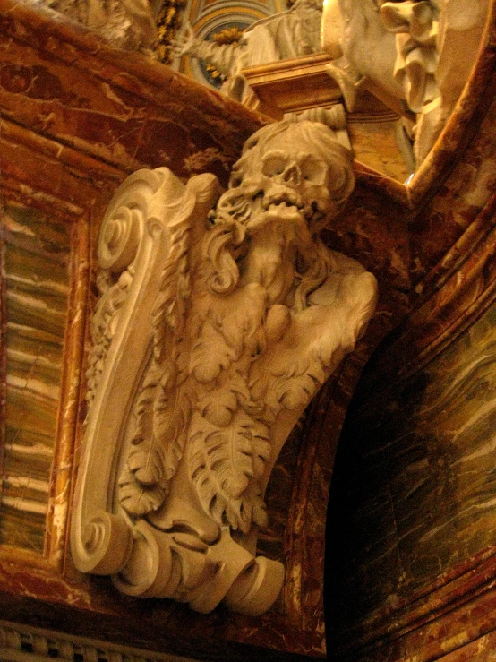 a wooden carving sits on top of a wood cabinet