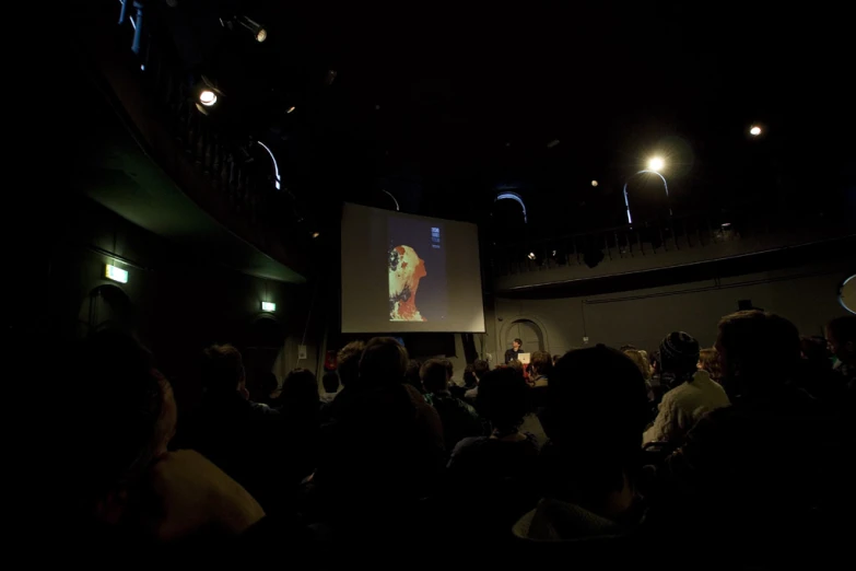 the audience watching the screen at the event