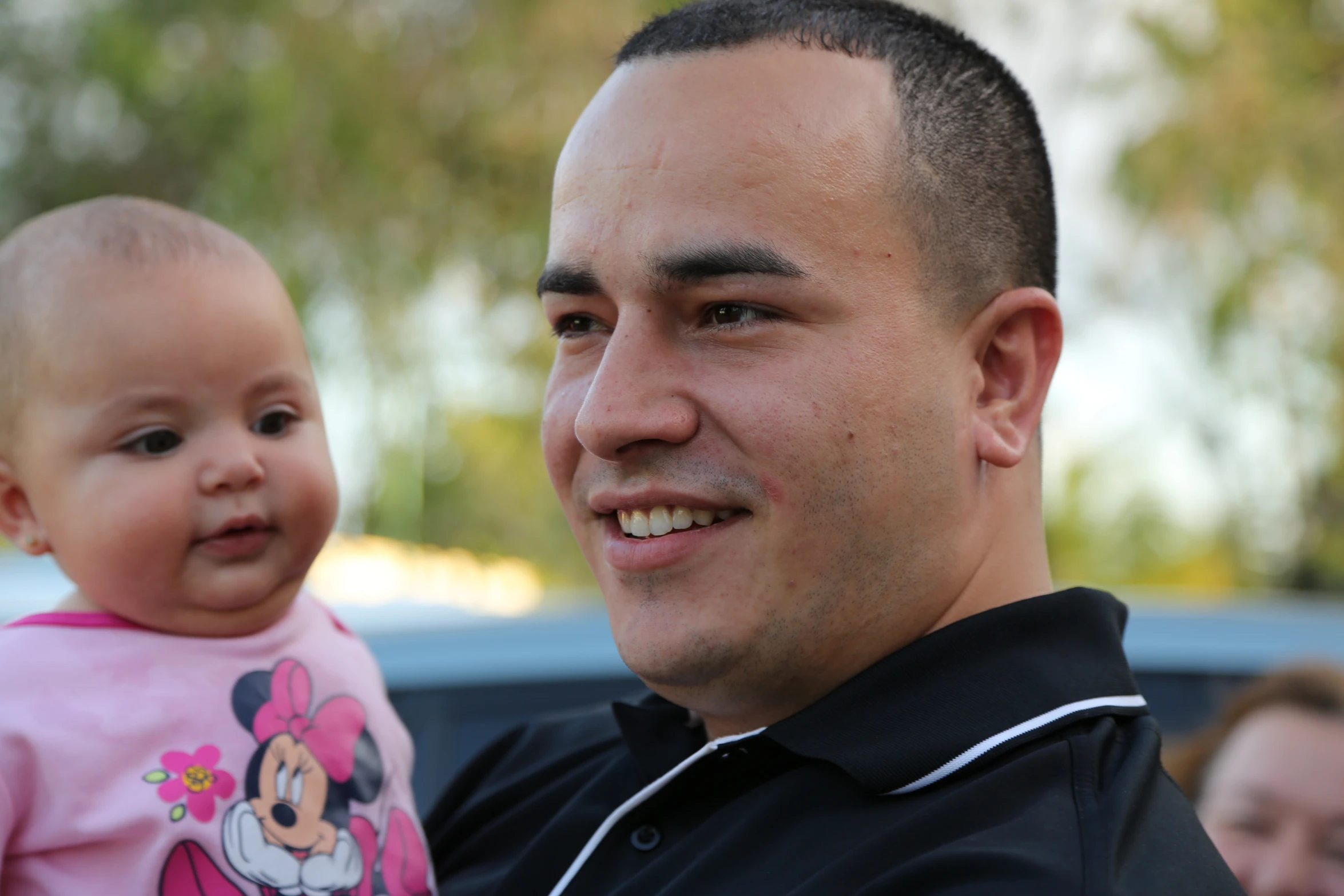 a man holding onto a baby in his arms