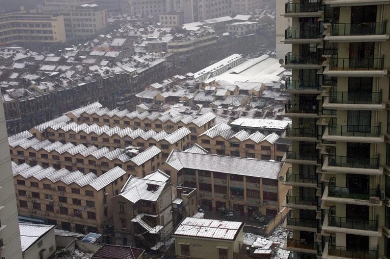a cityscape with buildings in the foreground and snowy roofs