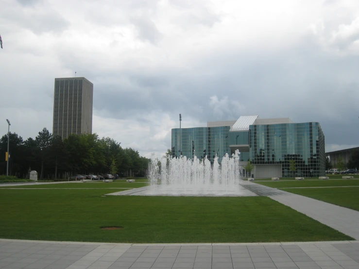 a view of water features with buildings in the background