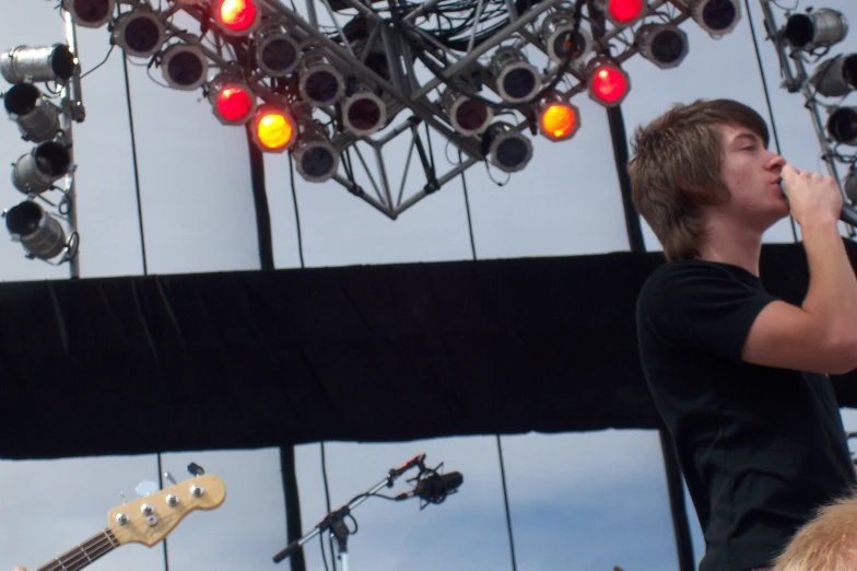 a boy on stage singing on his guitar