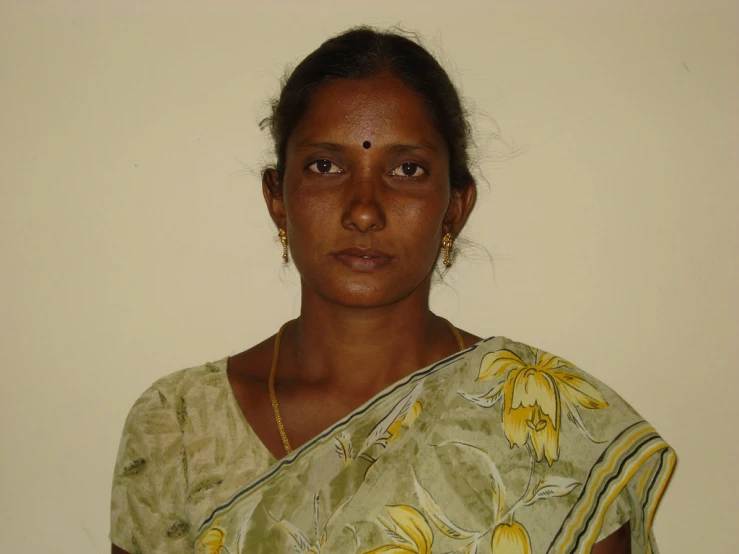 a woman in green and yellow sari