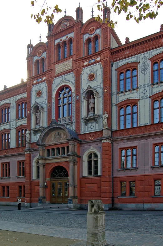 a building with multiple windows and a green flag