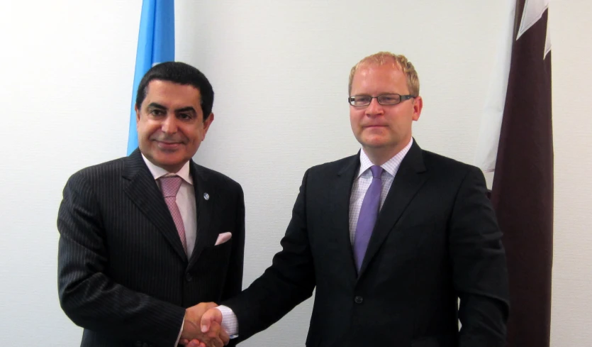 two men shaking hands in an office setting