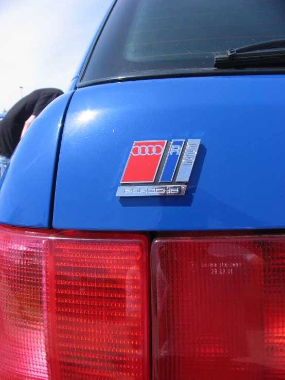 the back end of an automobile with red lights on it