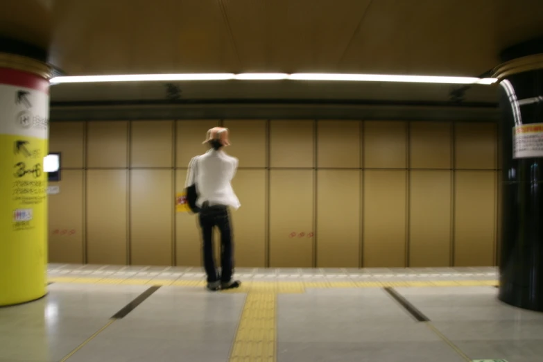 a woman standing next to a yellow and red container