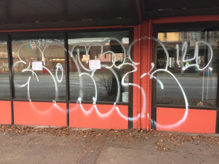a window is covered with graffiti in the street