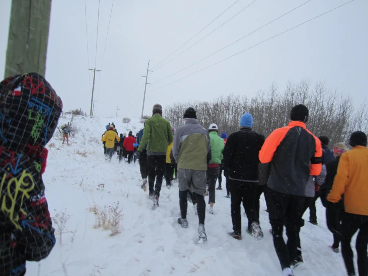 people walking up the hill on a snowy day